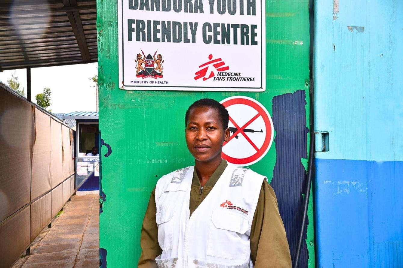 MSF community health educator standing outside youth center in Nairobi, Kenya.
