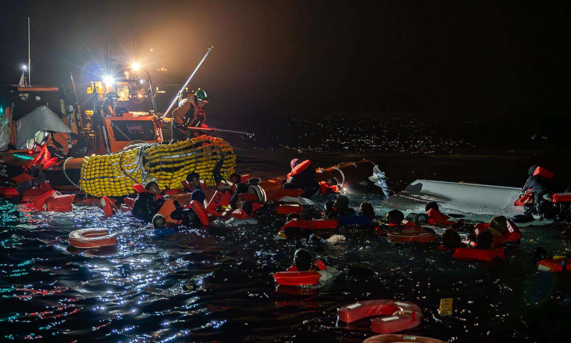 MSF search and rescue teams rescue migrants from a capsized boat in the Central Mediterranean.