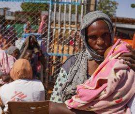 A displaced woman holding her child in Zamzam camp, North Darfur, Sudan.