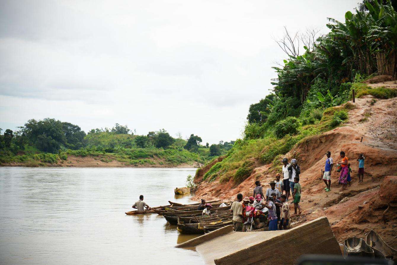 People next to a muddy river in Madagascar.